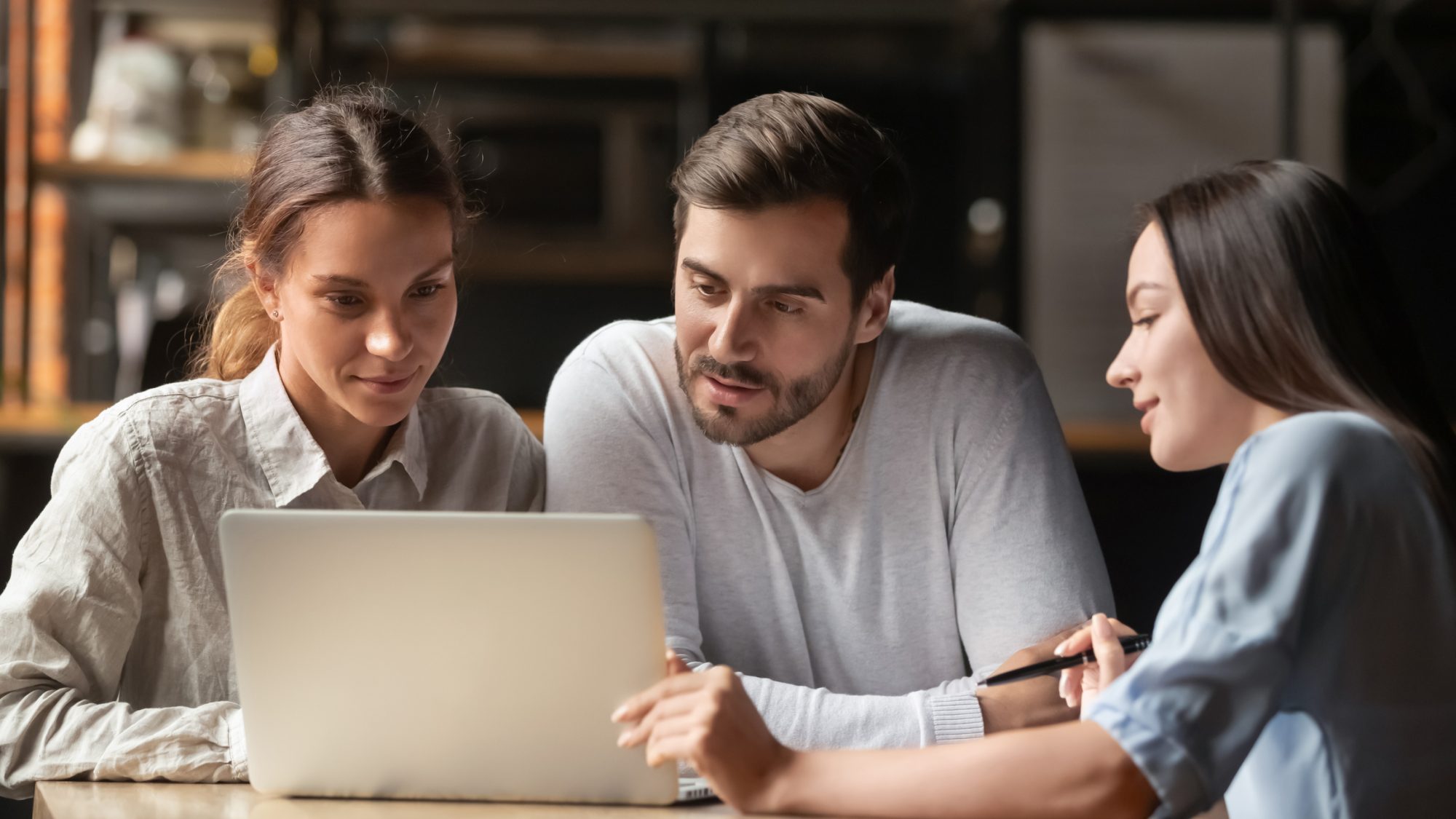 Female insurance mortgage broker agent consult young couple showing online presentation on laptop in office cafe, insurer financial advisor make business offer to interested clients look at computer